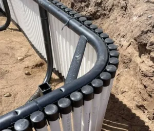 Curved underground piping installation in progress.