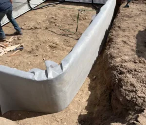 Installing a pool liner in backyard.